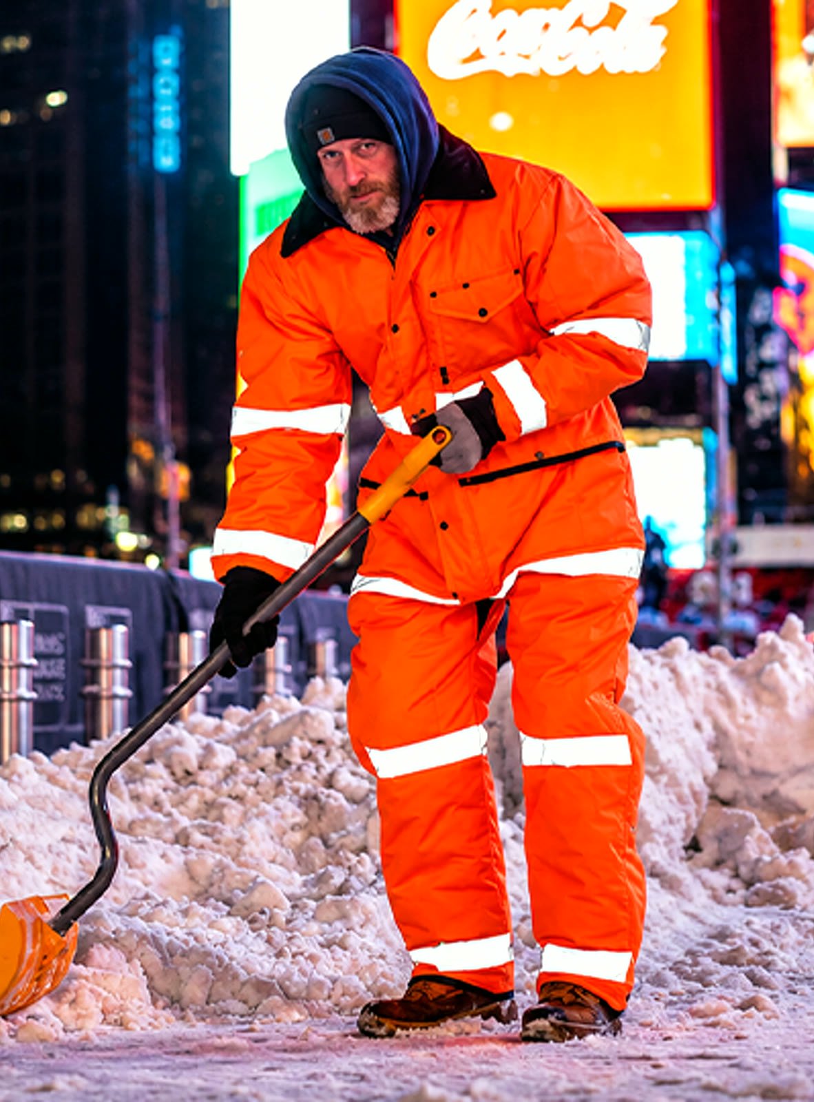 Tecbro worker in insulated jacket and trapper hat on snowy street