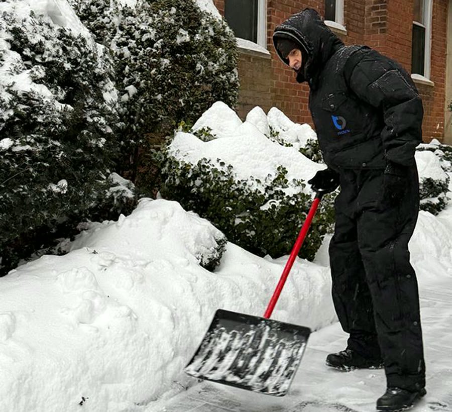 Worker in a branded Tecbro coverall in the snow
